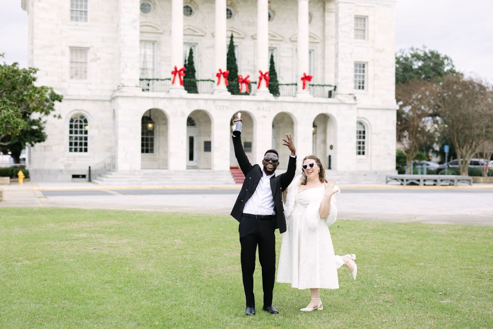 Redeemer and Ashton celebrating outside Mobile City Hall on their wedding day